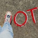 Picture of a person's feet in the shape of the letter V, followed by O T E to spell vote.