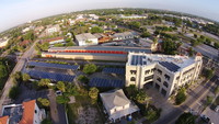 Medium_first_housing_hq__35kw_integ._tpo_roof__led_lts.__100kw_solar_car_ports__took_to_zero_energy