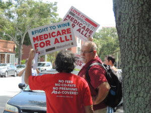 Medicare for All rally signs outside Charlie Crist's office