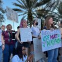 USF students stand with signs in support of the Deaf and Hard of Hearing community